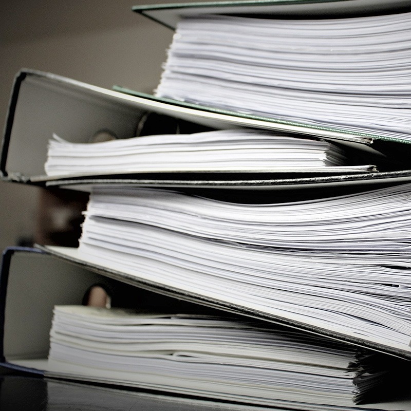 Stack of papers stored in file cabinet.