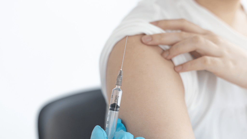 A woman receiving a medical injection in her arm.